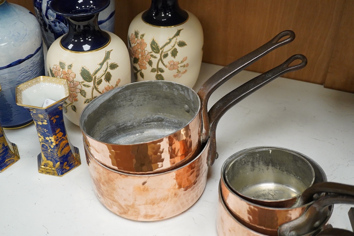 A set of five graduated hammered copper saucepans, largest 37cm in length